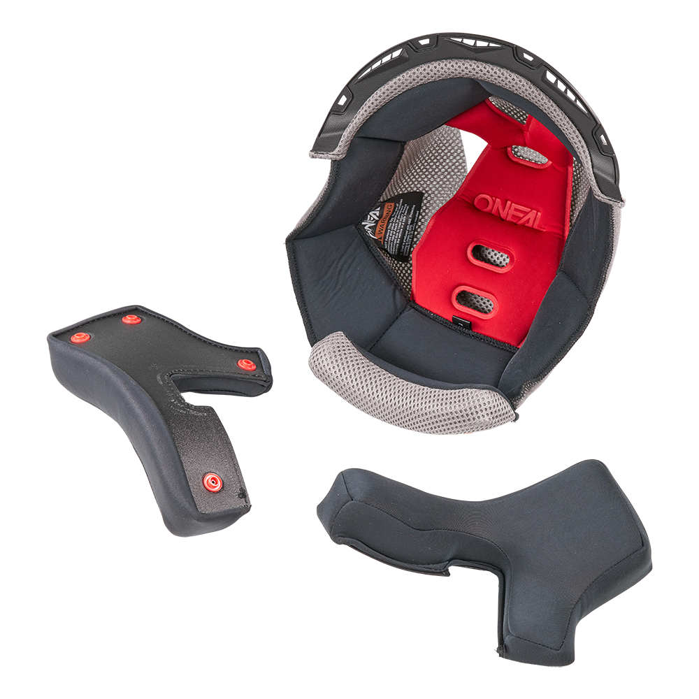 Casque O'NEAL Liner & Cheek Pads 1SRS montré enlevé et disposé sur un fond blanc. Les coussinets noirs/gris sont principalement noirs avec des accents gris, conçus pour les casques O'NEAL.