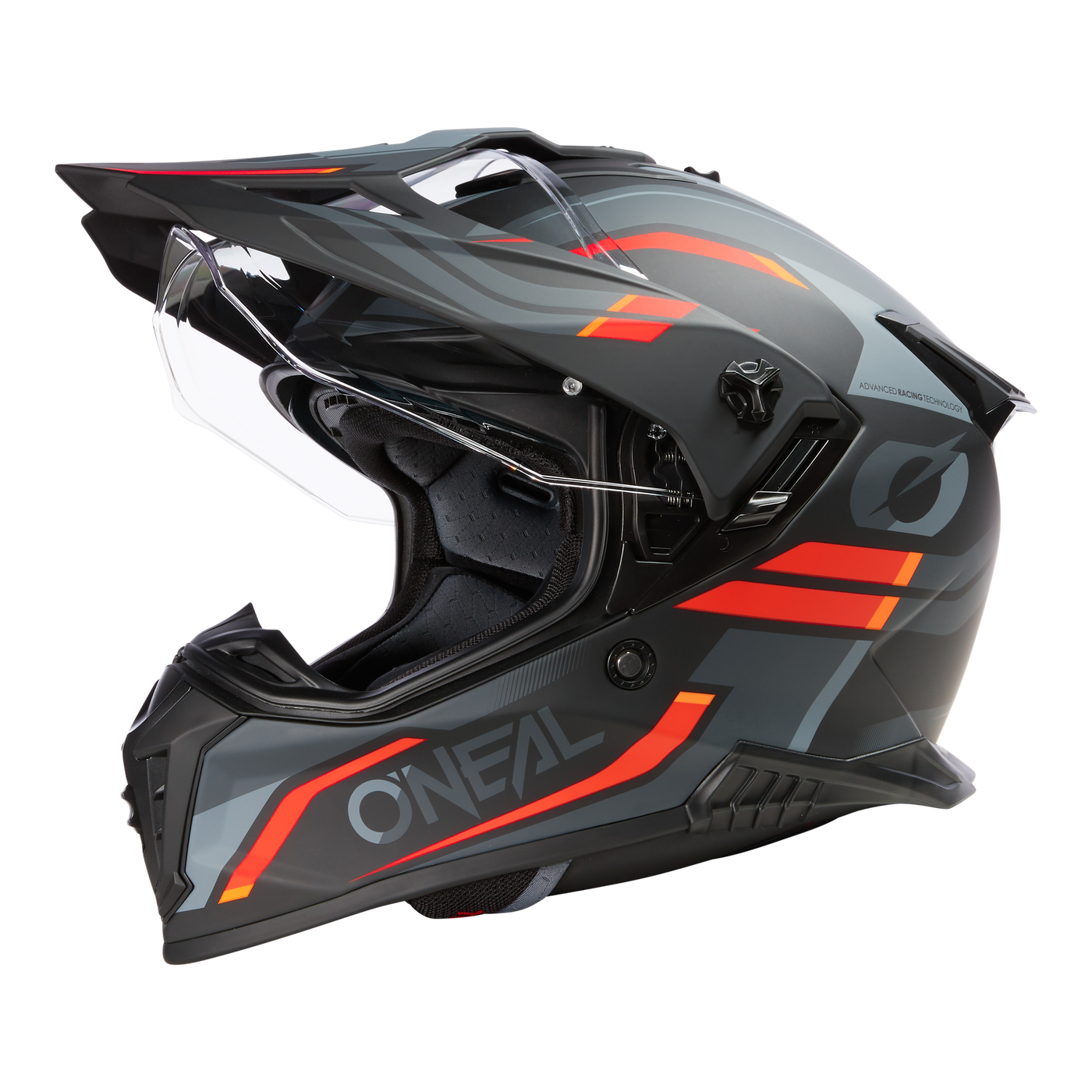 Der O'NEAL A-SRS Helm SPIKE ist ein mattschwarzer Motocross-Helm mit roten, orangefarbenen und grauen geometrischen Akzenten, klarem Visier, Sonnenschirm und Belüftung. Der Schriftzug "O'NEAL" ist an der Seite angebracht. Motorradhelm Bluetooth-Konnektivität unterstützt.