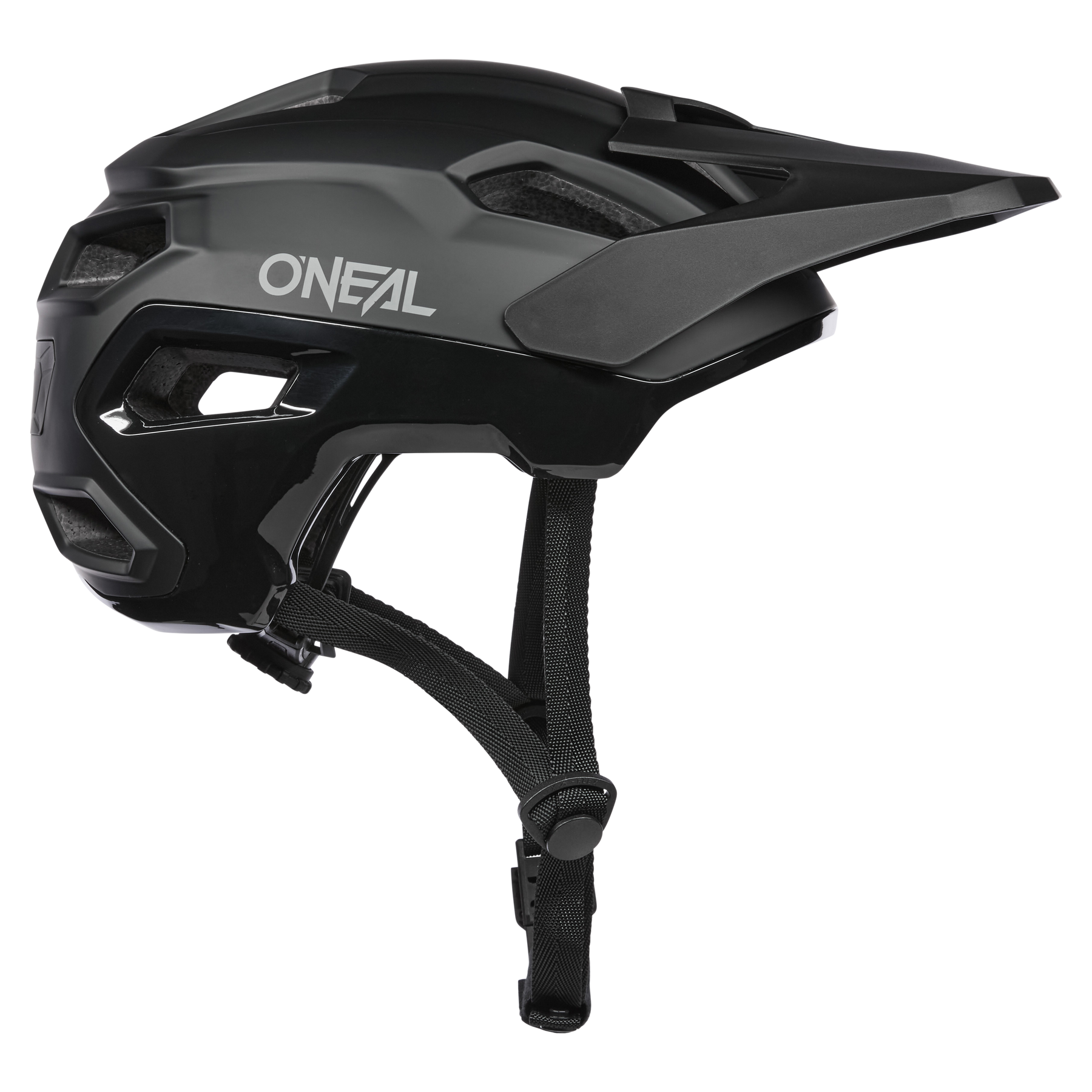 Der O'NEAL TRAILFINDER EVO Helmet SOLID in Schwarz und Dunkelgrau verfügt über ein Visier, verstellbare Kinnriemen und mehrere Belüftungsöffnungen. Er wird von der Seite auf einem transparenten Hintergrund dargestellt.
