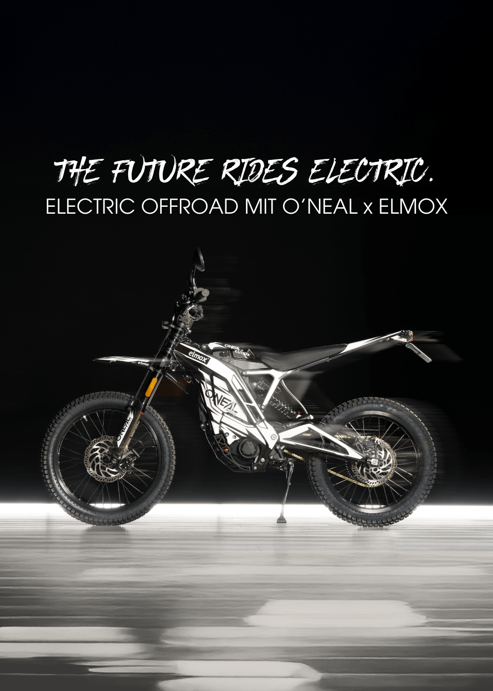 Ein schnittiges schwarz-weißes Elektro-Geländemotorrad der Marke O'NEAL x ELMOX steht auf einer reflektierenden Fläche mit dem Text "THE FUTURE RIDES ELECTRIC. ELECTRIC OFFROAD MIT O'NEAL x ELMOX" darüber.