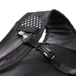 Close-up of the black mesh strap of the O'NEAL Europe JUNCTION Protective Backpacks with plastic buckle, white grid stitching and a ventilated area with small white dots for added breathability.