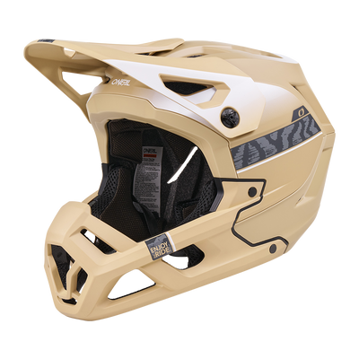Der O'NEAL SL1 Helm TERRA ist ein sandfarbener Fullface-Mountainbike-Helm mit schwarzer Innenausstattung, Belüftungsöffnungen, Visier, dezenten Seitenstreifen und Branding - bietet optimalen Schutz als Ausrüstung für anspruchsvolles Terrain.