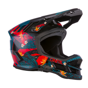 Der O'NEAL BLADE Polyacrylite Helm RIO ist ein Integralhelm für Motocross mit einem lebendigen Design mit tropischen Elementen, darunter rote, gelbe und orangefarbene Blumen und grüne Blätter. Dieser überwiegend schwarze Helm wird durch rote und blaugrüne Details akzentuiert. Der Markenname „O'NEAL“ ist an mehreren Stellen prominent angebracht und unterstreicht sein markantes Erscheinungsbild.