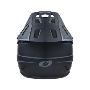 Eine Draufsicht auf den O'NEAL BACKFLIP Helm SOLID von O'NEAL, der sein schwarzes, aerodynamisches Design mit geometrischen Belüftungsmustern und einem glatten, matten Finish zeigt. Der Helm verfügt über ein minimalistisches Grafiklogo auf der Vorderseite und bietet sowohl Stil als auch Sicherheit für Mountainbike-Experten.