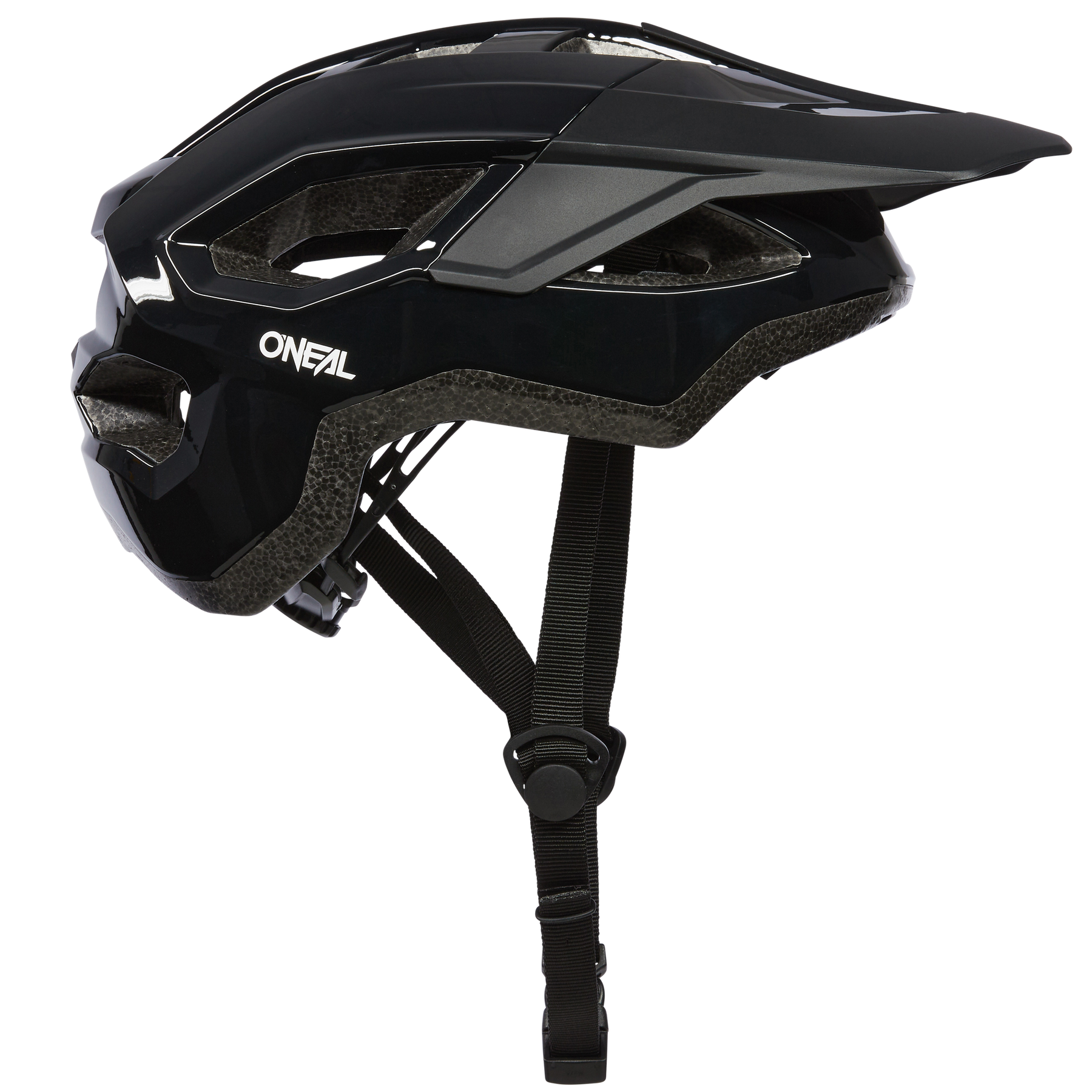 Seitenansicht eines schwarzen O'NEAL MATRIX Helms SOLID, der für Mountainbike- und Trekkingtouren konzipiert wurde und über eine robuste Struktur mit mehreren Belüftungsöffnungen, ein verstellbares Visier und einen sicheren Kinnriemen verfügt. Der Helm hat das „O'NEAL“-Branding an der Seite und ist Teil der O'NEAL Matrix-Kollektion.