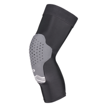 Der O'NEAL DIRT 1.0 Knieschützer ist ein schwarz-grauer Knieschützer mit einem konturierten, perforierten Polster zum Schutz und einem weißen Wellenlinien-Design, das flexiblen, ergonomischen Halt bietet.